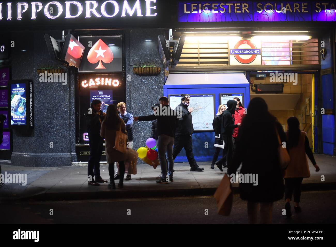 People outside Leicester Square Underground station in London, after a range of new restrictions to combat the rise in coronavirus cases came into place in England. Stock Photo