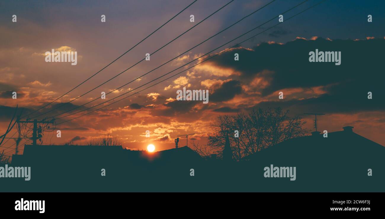 Low angle shot of electricity wires under sunset sky Stock Photo - Alamy