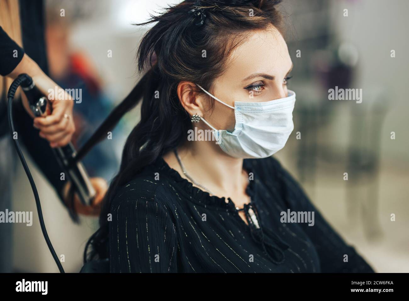Woman in medical mask gets her hair done in beauty salon during pandemic Stock Photo Alamy