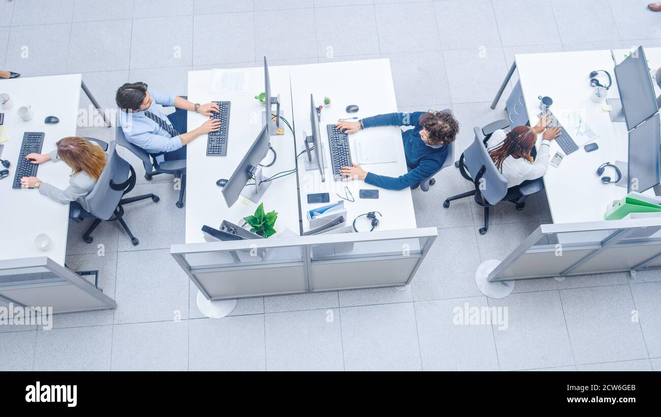 In the Bright Busy Office Rows of Diverse Professionals Working on ...