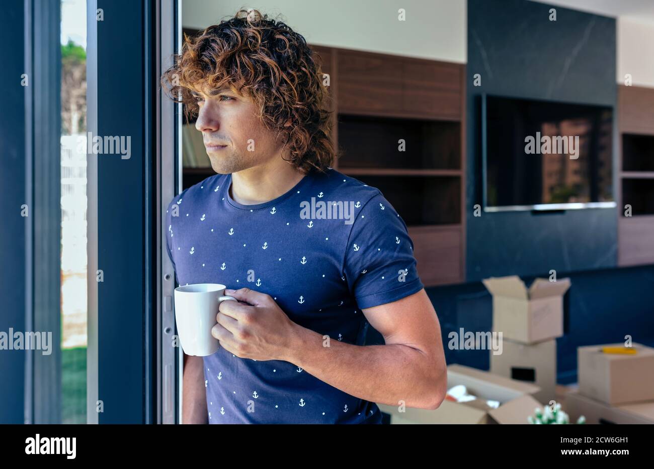 Man resting from unpacking moving boxes Stock Photo