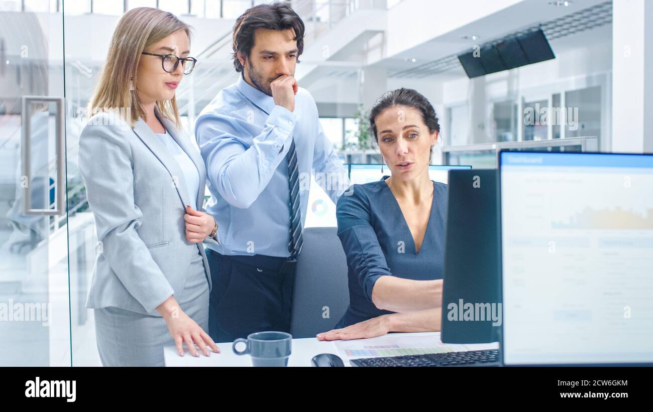 In Bright Modern Office: Office Worker Sitting and Working at Her ...