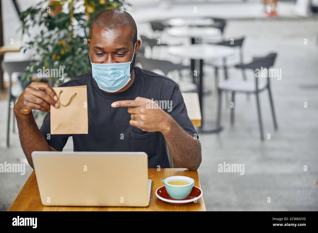 Person demonstrating lovely present on the web camera Stock Photo