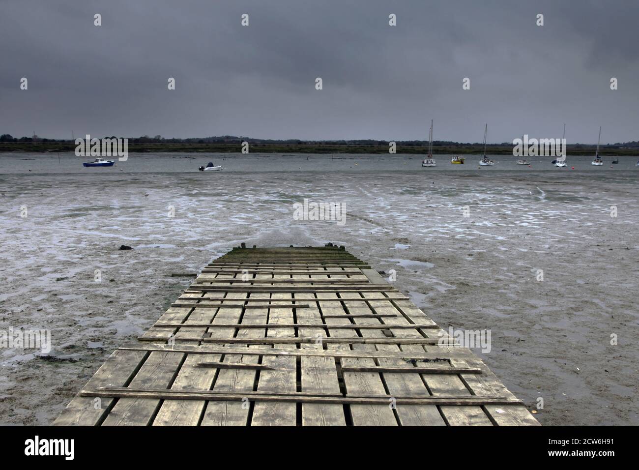 Board walk on salt marshes of the river estuary on Mersea Island Essex Stock Photo