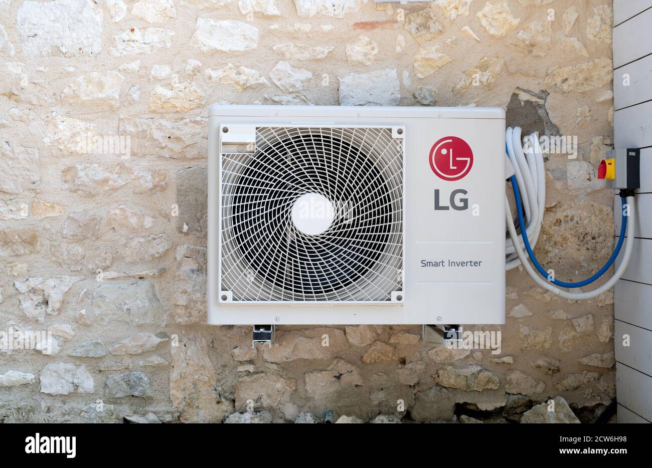 Bergerac, France July 2020: An LG smart inverter mounted on the stone wall of a house Stock Photo