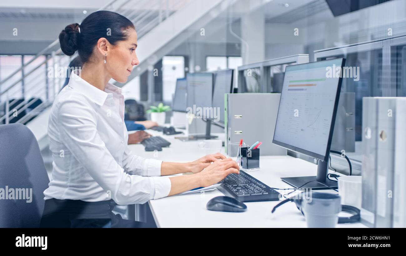 Young Handsome Female Manager is Working on Her Personal Computer with ...