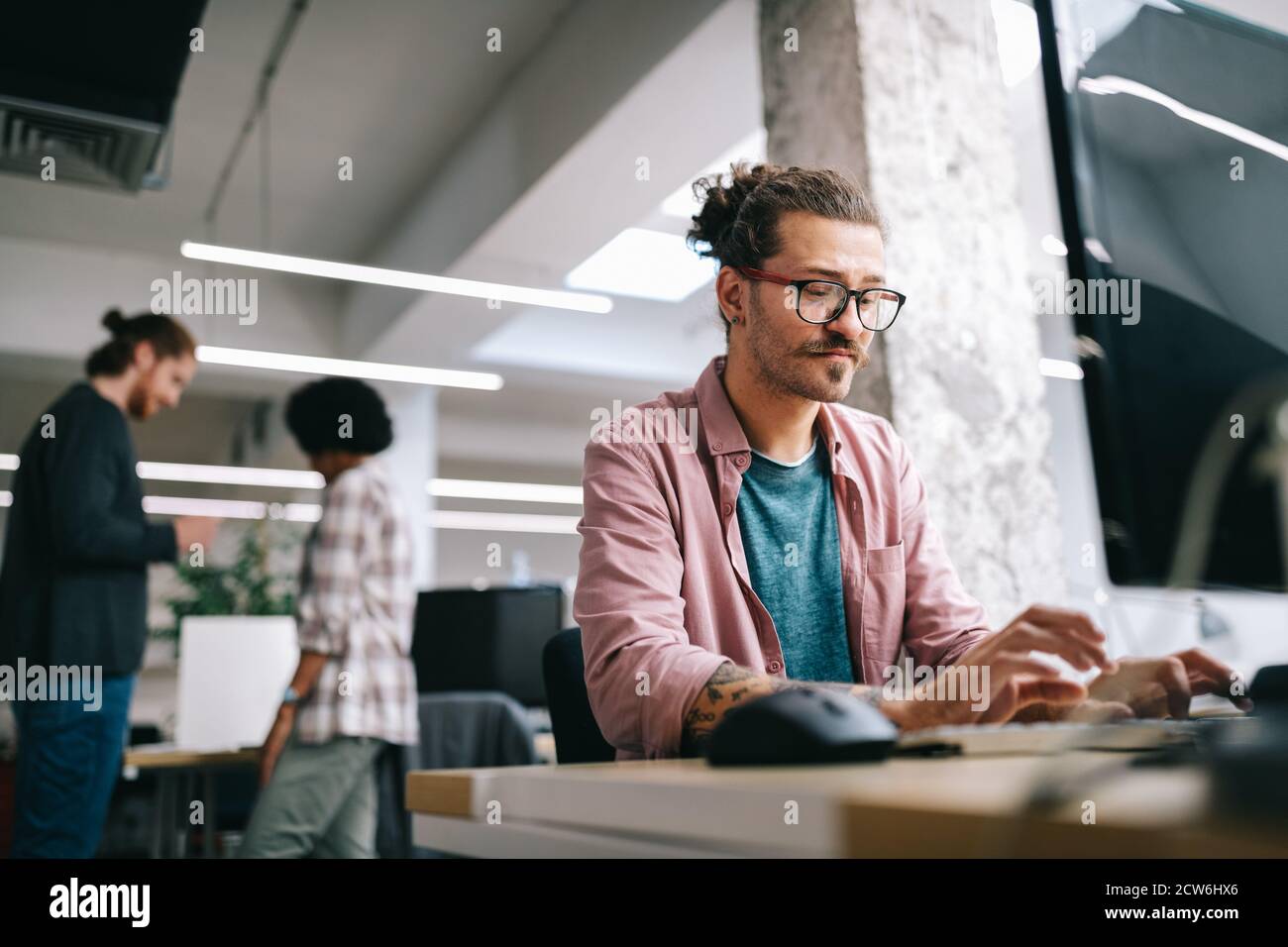 Programmer working and developing software in office Stock Photo