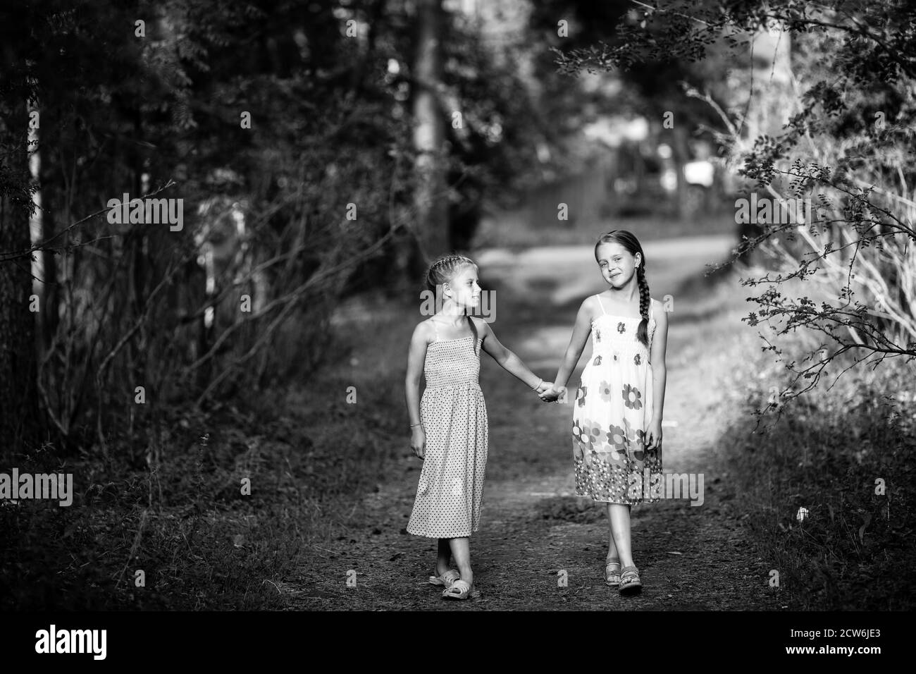 Two little girlfriends in the park. Black and white photo Stock Photo ...