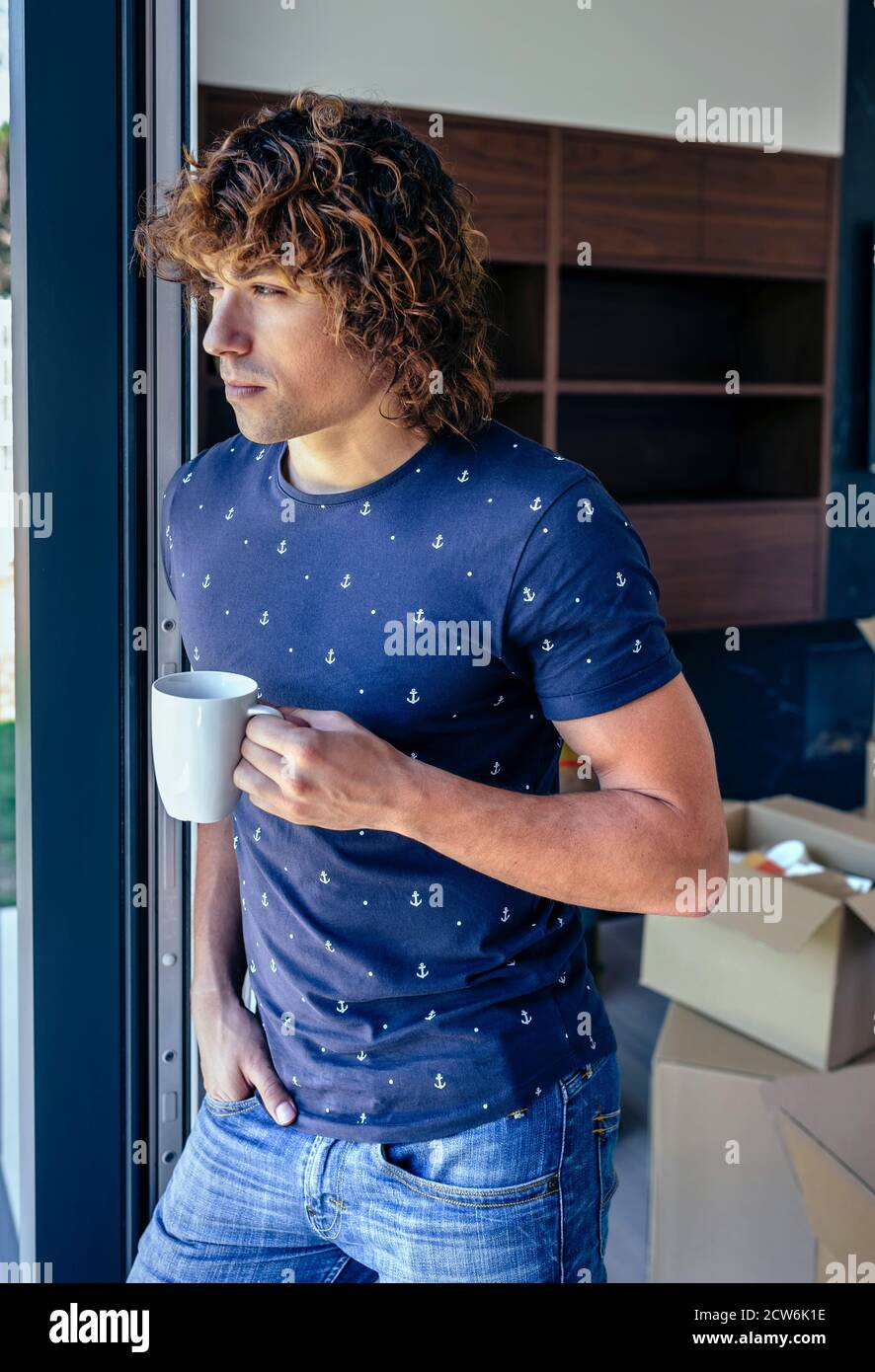 Man resting from unpacking moving boxes Stock Photo
