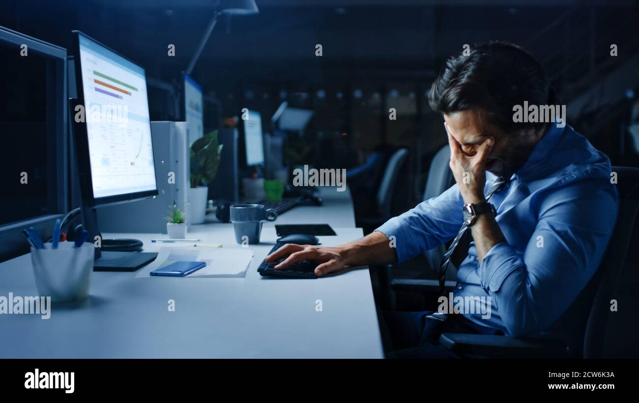 In the Office at Night Overworked Tired Office Worker Uses Desktop ...