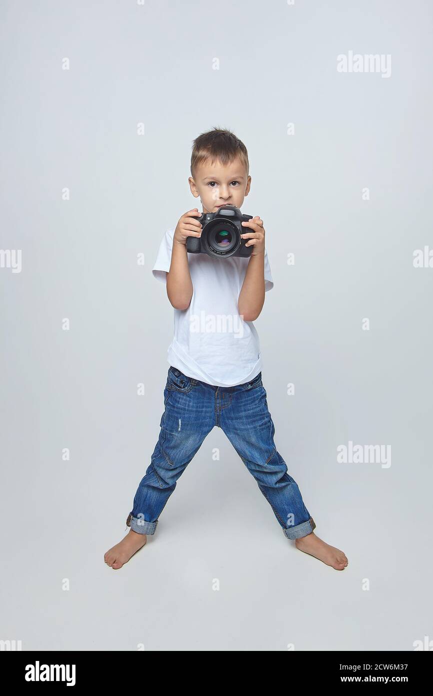 cute boy posing with a camera in a Studio on a white background Stock ...