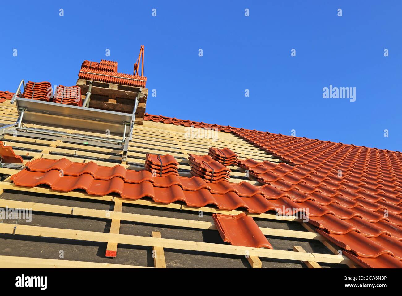 Roofing work, new covering of a tiled roof Stock Photo Alamy