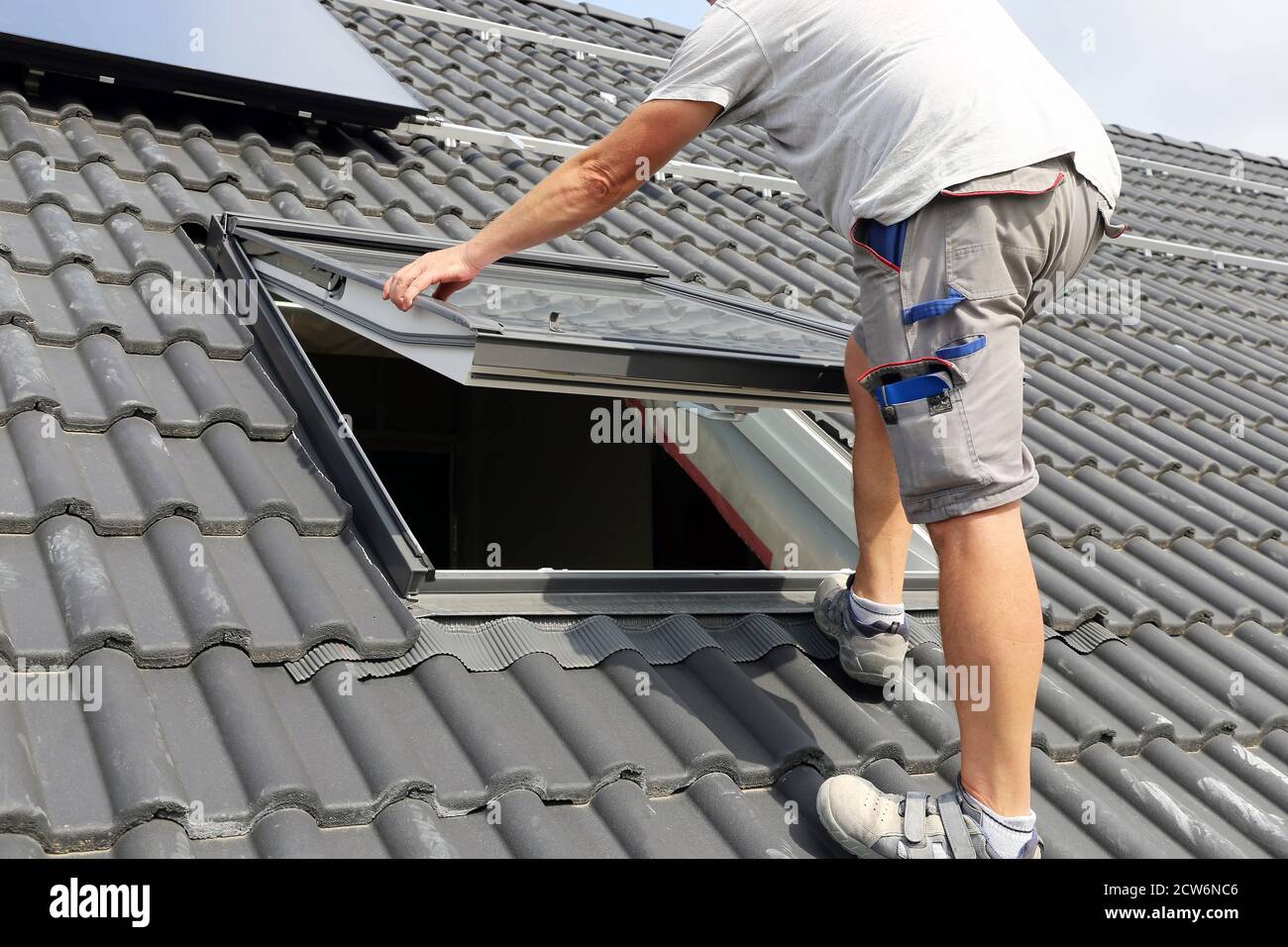 Installation and assembly of new roof windows as part of a roof covering Stock Photo Alamy