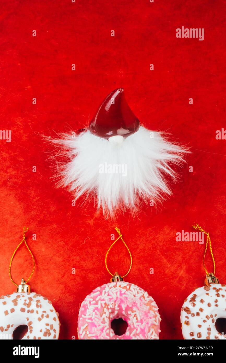 Santa Claus Figurine On Red Background With Delicious Donuts Form As Christmas Sweet Tree Toys Copy Space Greeting Card Merry Christmas Noel Stock Photo Alamy