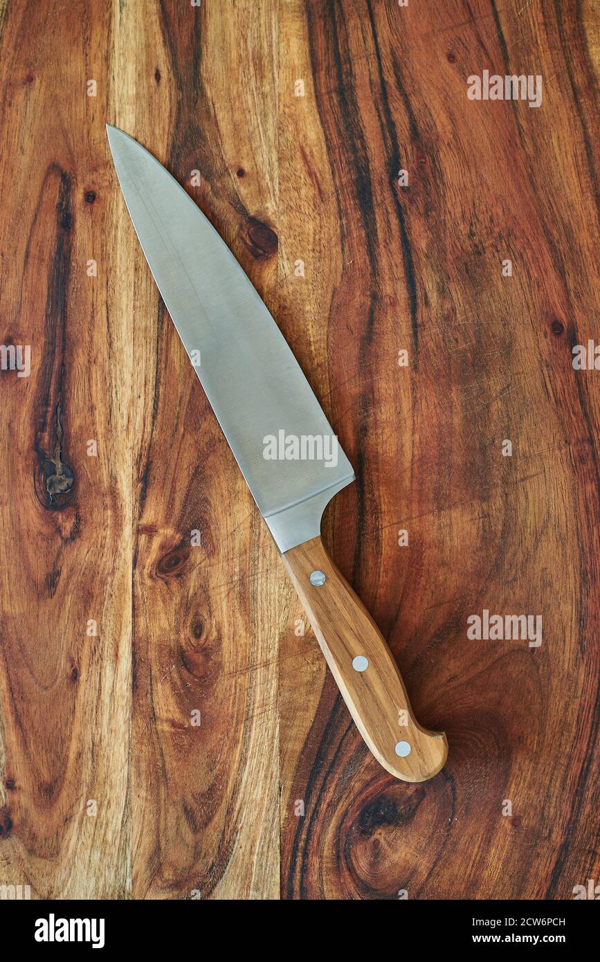 Professional chef knife, peeling knife and sharpening steel on wood cutting  board over a kitchen table. Chef working tools. Modern kitchen utensils  Stock Photo - Alamy
