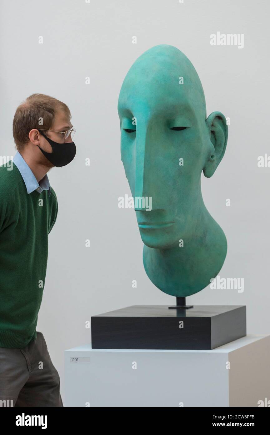 London, UK.  28 September 2020.  A staff member views 'Head II' by Tim Shaw, RA.  Preview of the Summer Exhibition at the Royal Academy of Arts in Piccadilly which, due to the Covid-19 lockdown, is taking place for the first time in the autumn.  Over 1000 works in a range of media by Royal Academicians, established and emerging artists, feature in the exhibition which runs from 6 October 2020 – 3 January 2021.  Credit: Stephen Chung / Alamy Live News Stock Photo