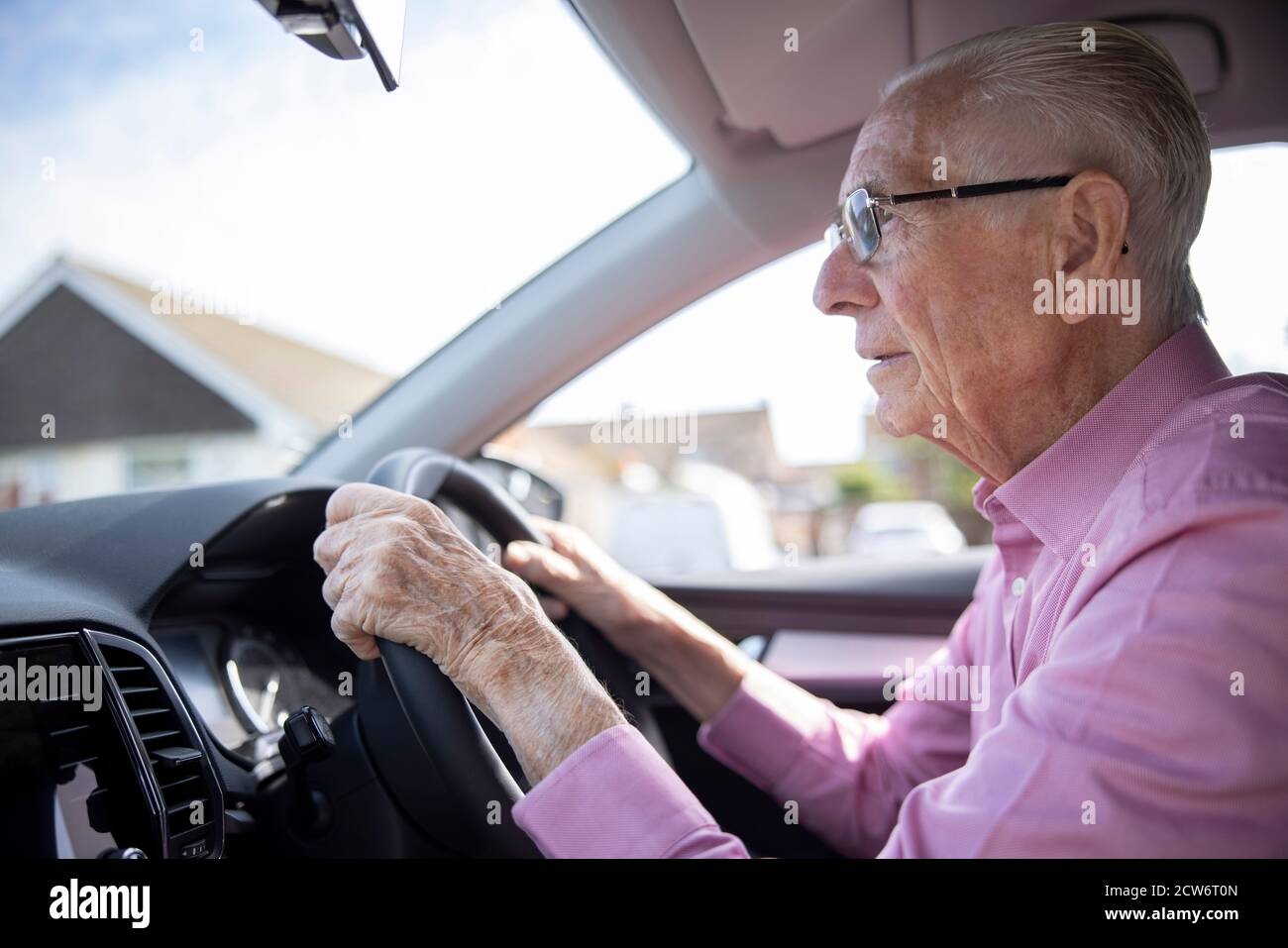 Worried Senior Male Driver Looking Through Car Windscreen Stock Photo