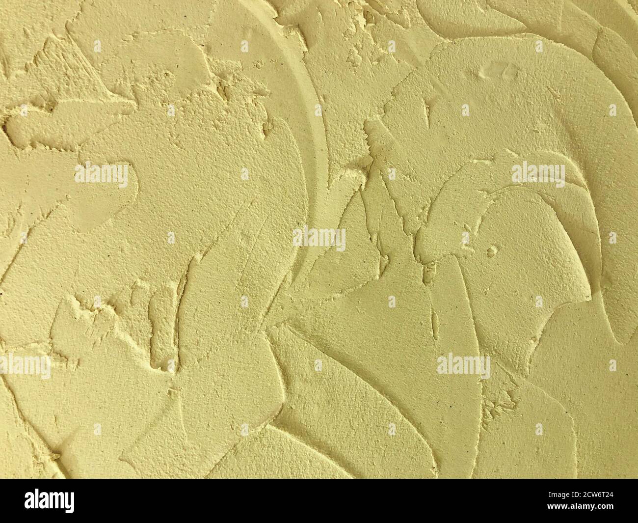 Textured yellow colored plaster. Wall stucco texture. Plastered background Stock Photo