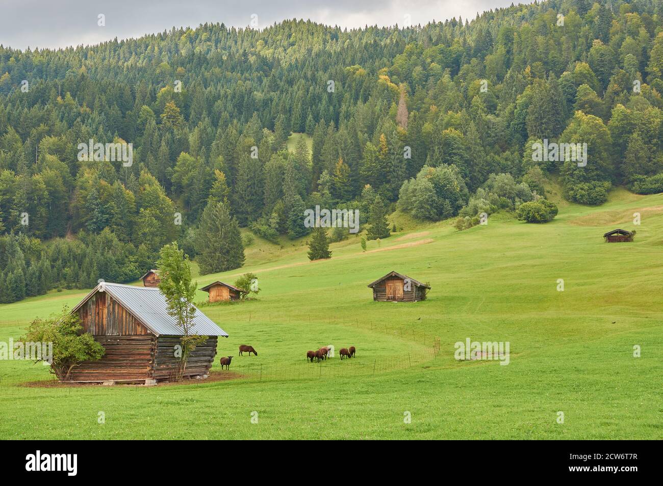 Beautiful mountain landscape with mountain cabins and a mountain lake in  the alps Stock Photo - Alamy