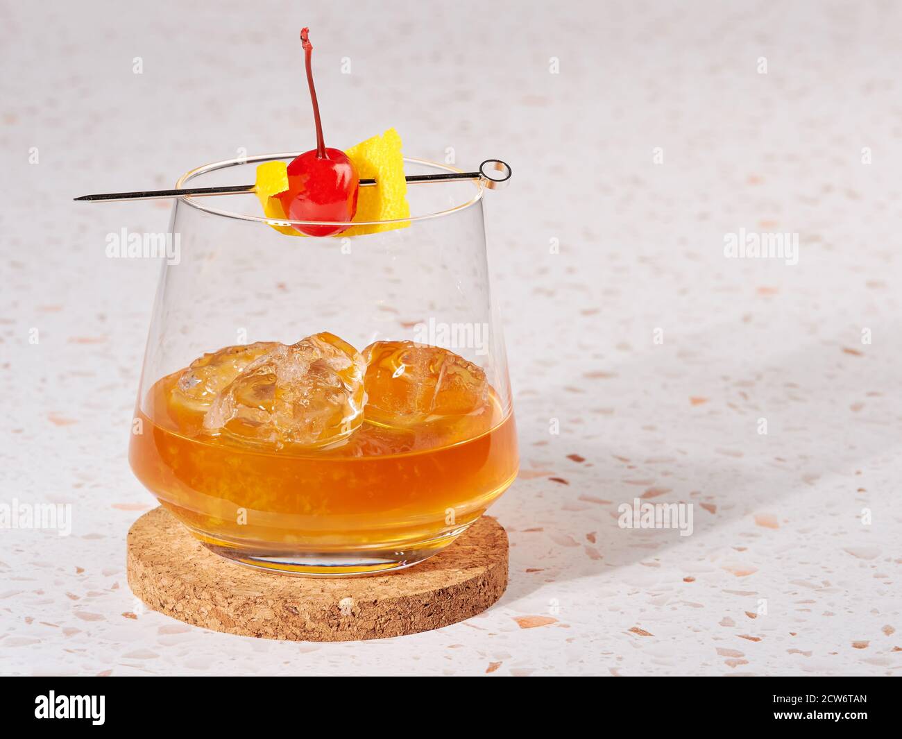 Old fashioned: a cocktail made by muddling sugar with bitters, then adding bourbon, and a twist of citrus rind Stock Photo
