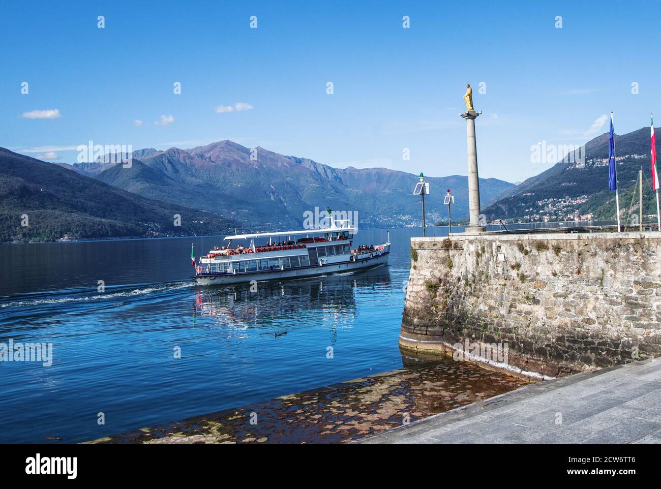 tourist boat sails on a clear day on Lake Maggiore in the locality of Luino, Italy Stock Photo