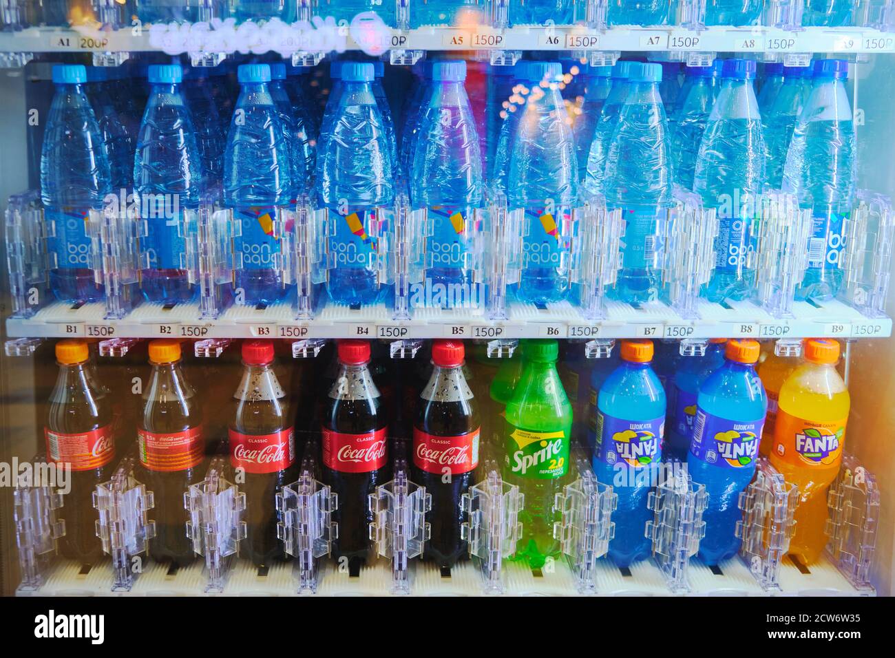 Bottles of water and fizzy drinks inside of vending machine Stock Photo