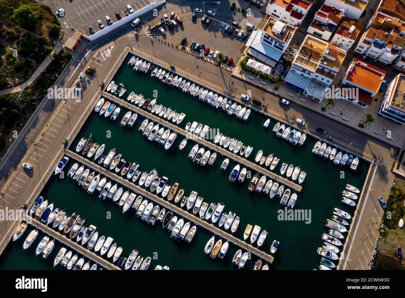 Aerial view of the harbour and boats moored in the fishing village of Llanca on the Costa Brava, Catalonia, Spain Stock Photo
