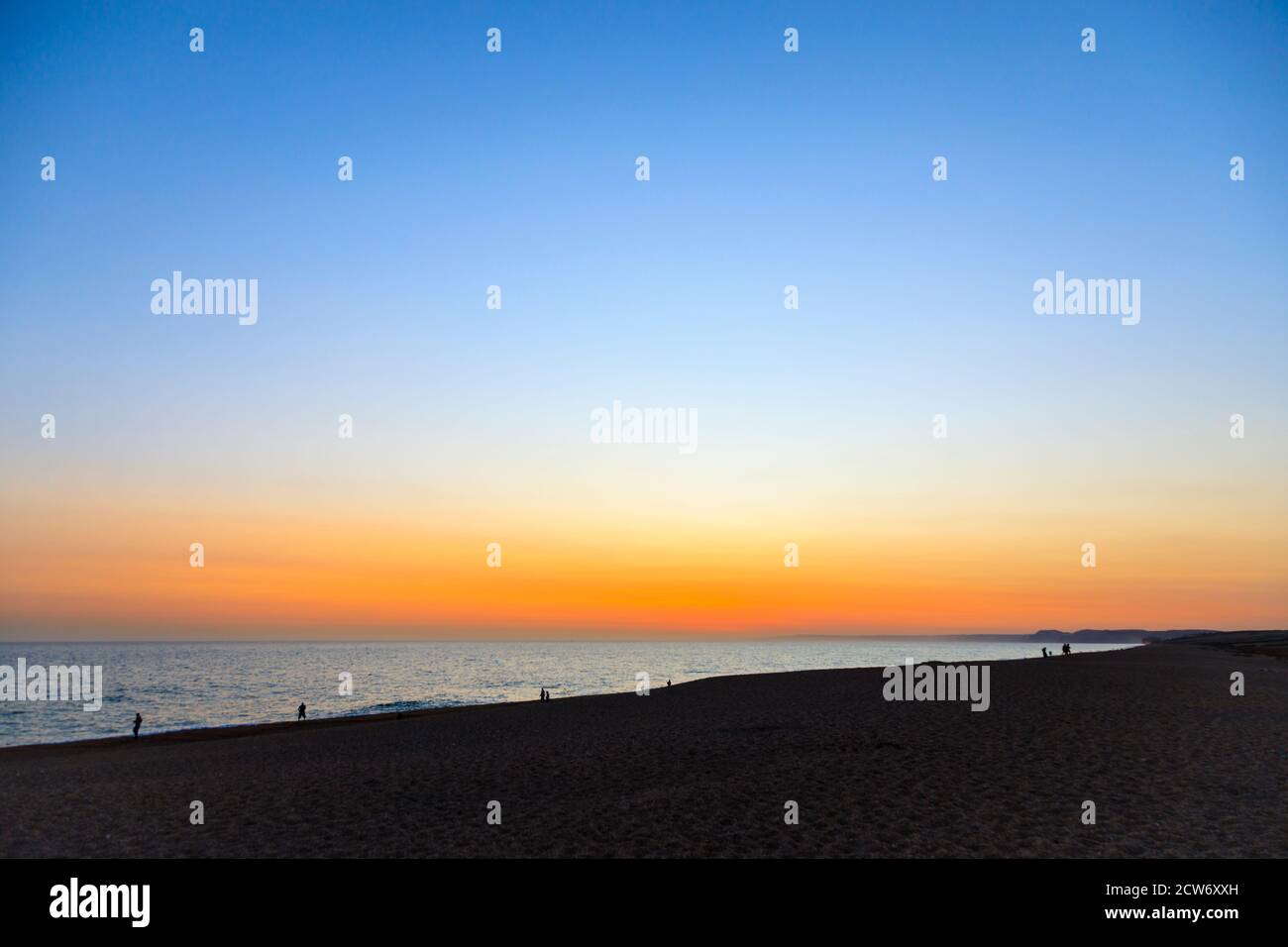 Sunset and the shoreline at the beach at West Bexington, a village in