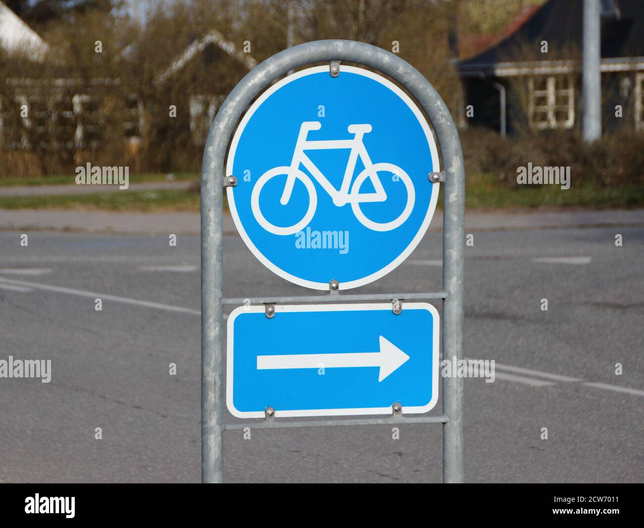 A blue traffic road sign signifying a right turn for bicycles. Stock Photo