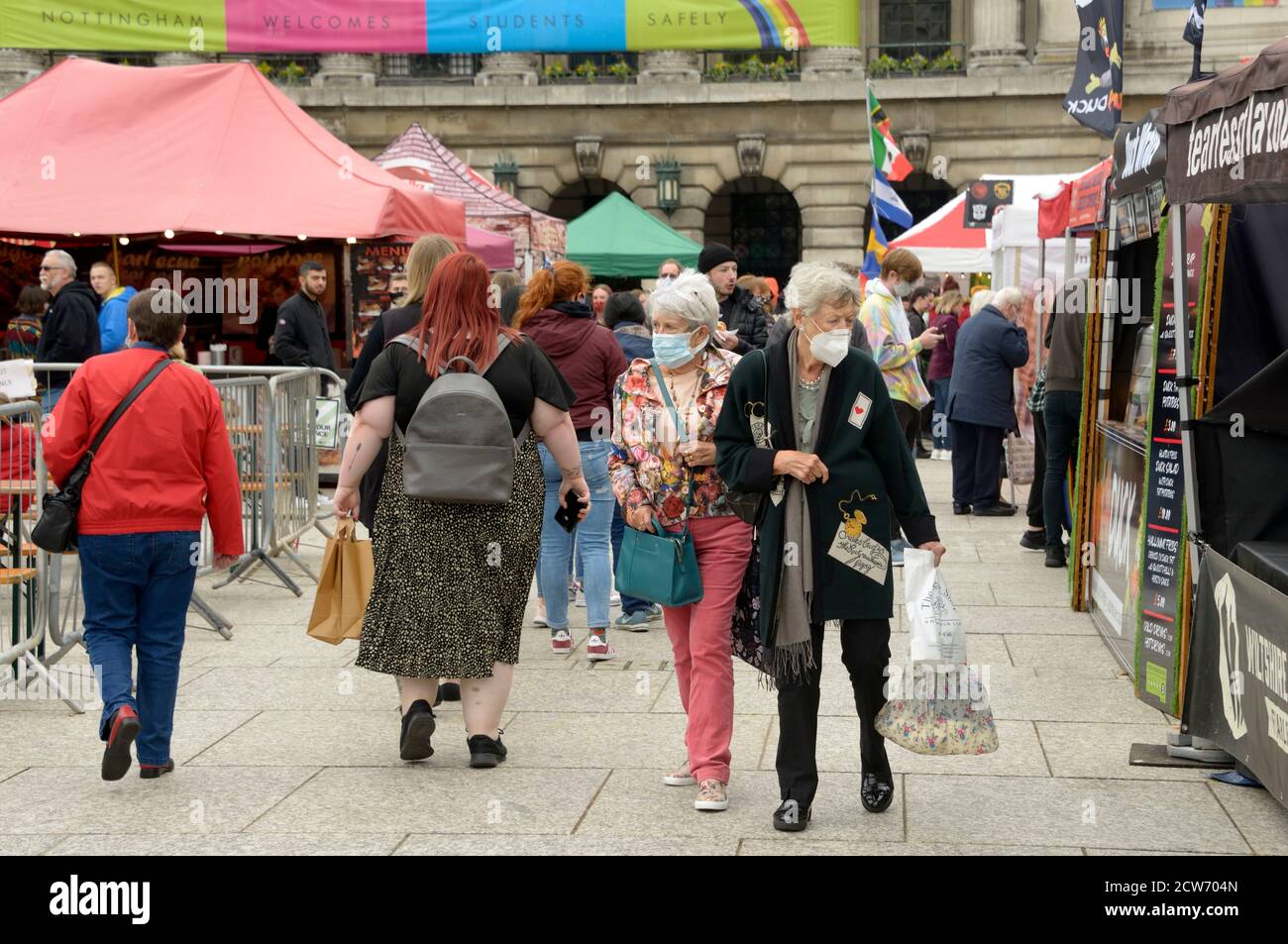 Two slim old ladies, passing an obese young woman. Stock Photo