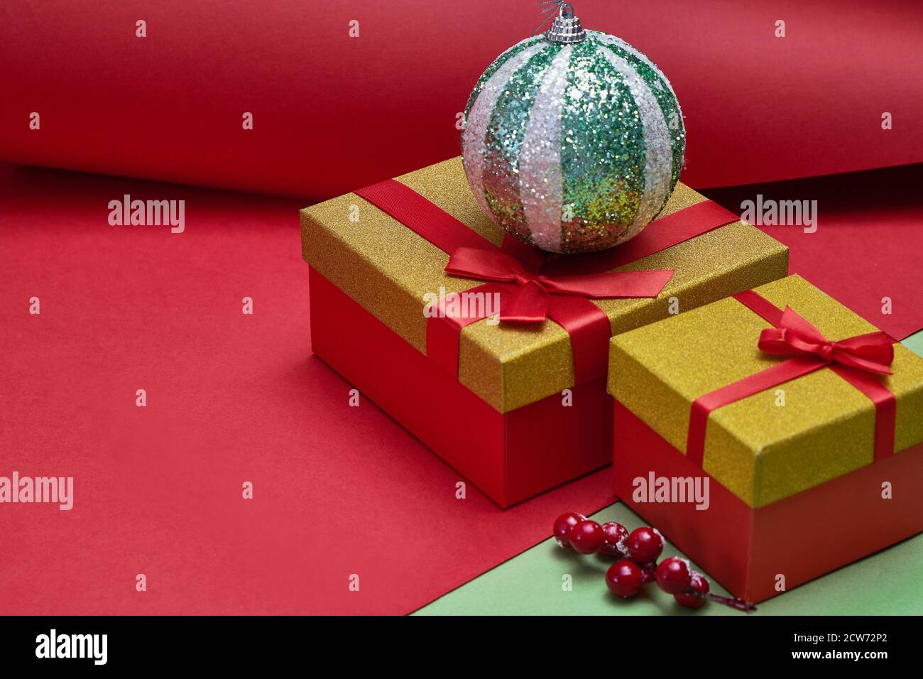 Gifts boxes, Christmas decorations on green and red paper background ...
