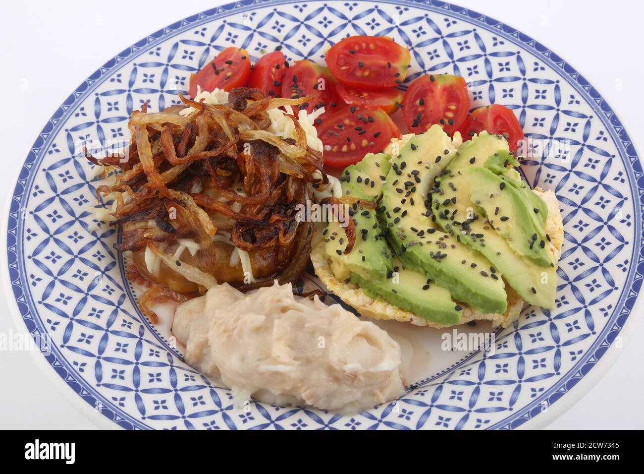 combinated dish with avocado tomatoes hummus and onions Stock Photo