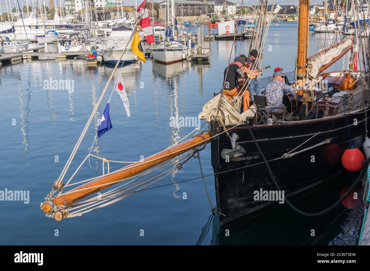 Group called The Black Tar Roses performing from the deck of a boat, a  Bristol Pilot Cutter, called Olga, in Plymouth Barbican harbour Stock Photo  - Alamy