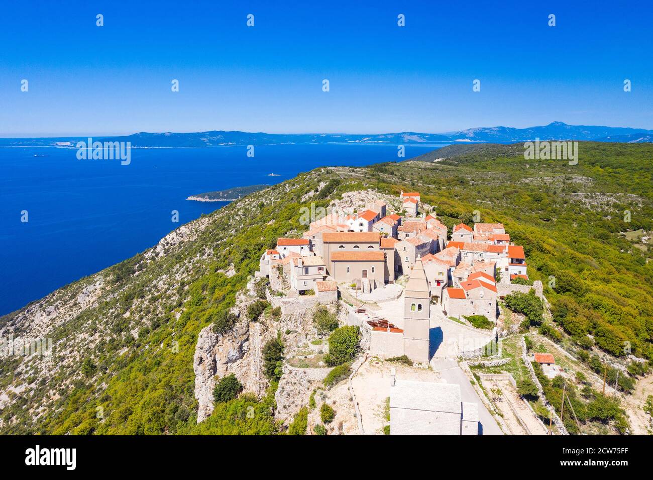 Aerial view of small historical town of Lubenice on the high cliff, Cres island in Croatia, Adriatic sea in background Stock Photo