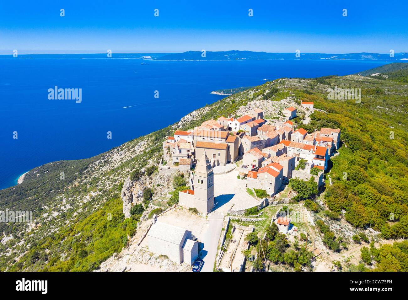 Aerial view of small historical town of Lubenice on the high cliff, Cres island in Croatia, Adriatic sea in background Stock Photo