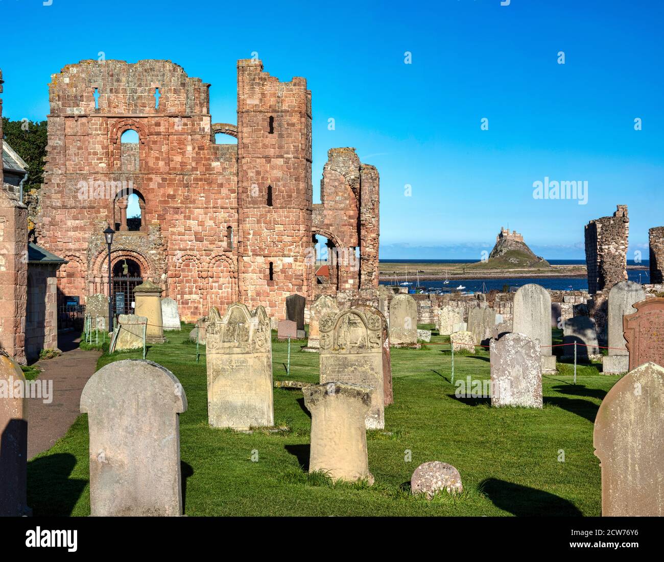 Lindisfarne Priory and Lindisfarne Castle in summer on Lindisfarne near Berwick upon Tweed, Northumberland, England, United Kingdom Stock Photo