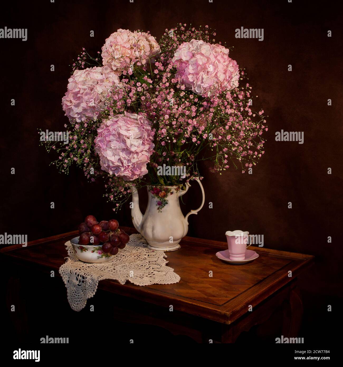 still life study with pink hydrangeas and grapes Stock Photo