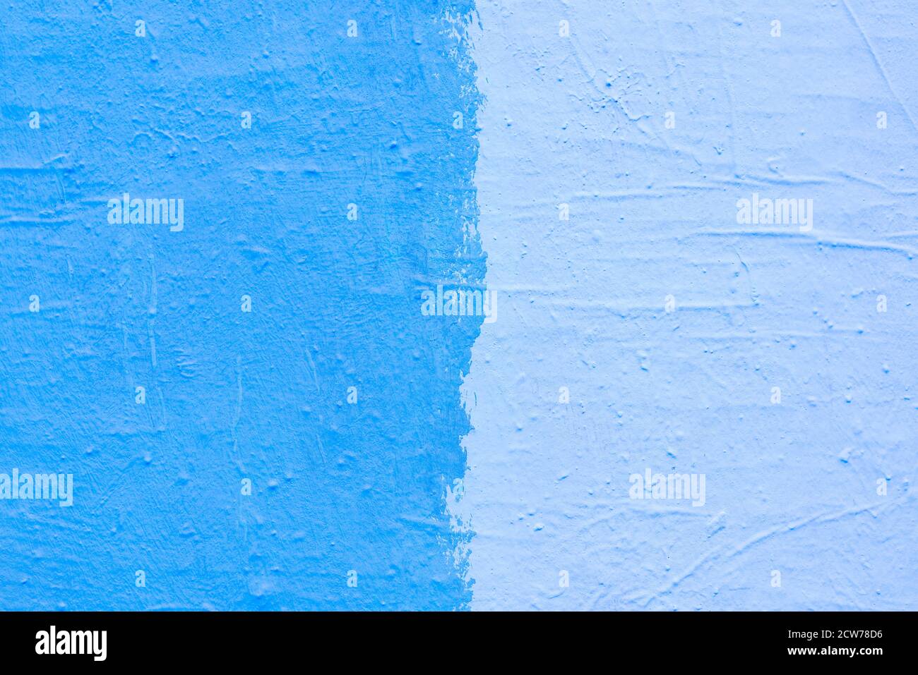 Blue paint texture. Interior of a modern loft. Abstract bright background. The facade of an old house. Divided in half. Stock Photo