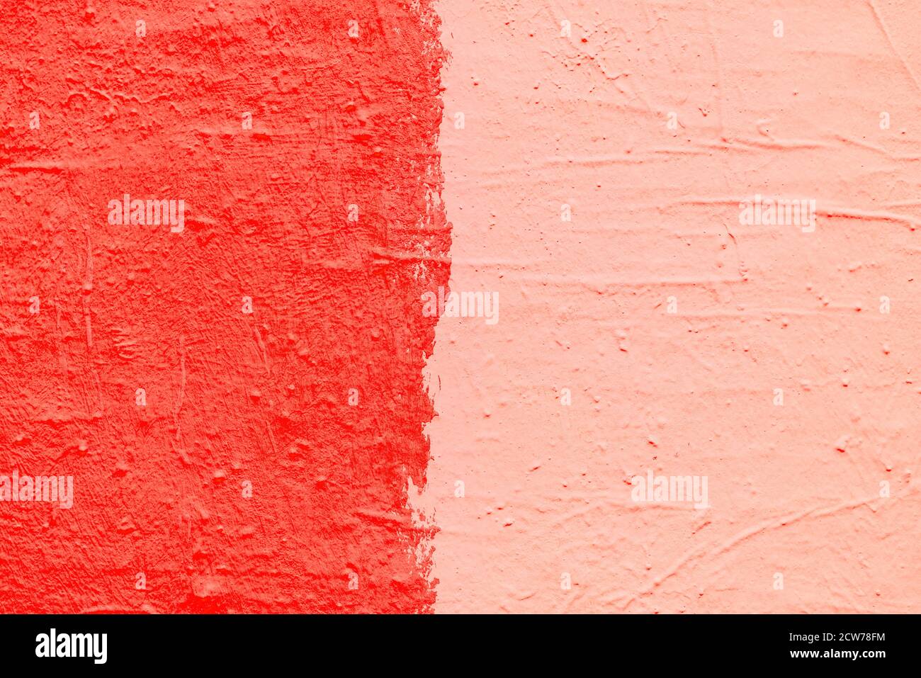 Red paint texture. Interior of a modern loft. Abstract bright background. The facade of an old house. Divided in half. Stock Photo
