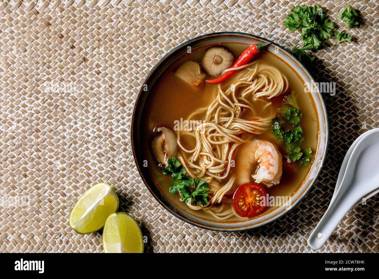 Asian spicy noodles soup with shiitake mushrooms and prawns