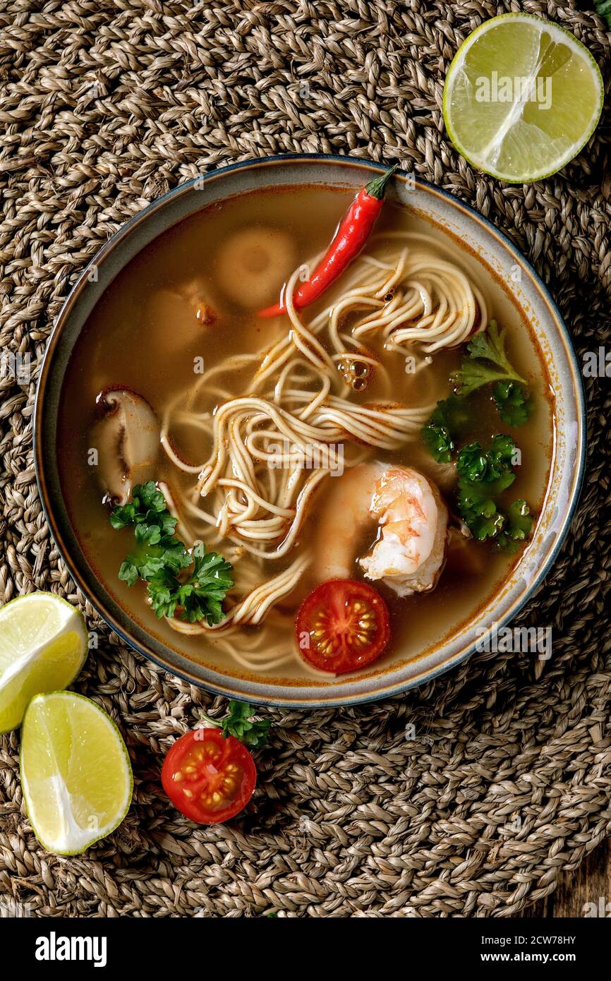 Asian spicy noodles soup with shiitake mushrooms and prawns