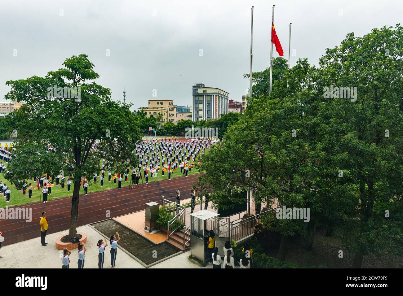 ZHONGSHAN China-September 28,2020:Chinese pupils and teaches attending a flag-raising ceremony in the morning in a primary school. Stock Photo