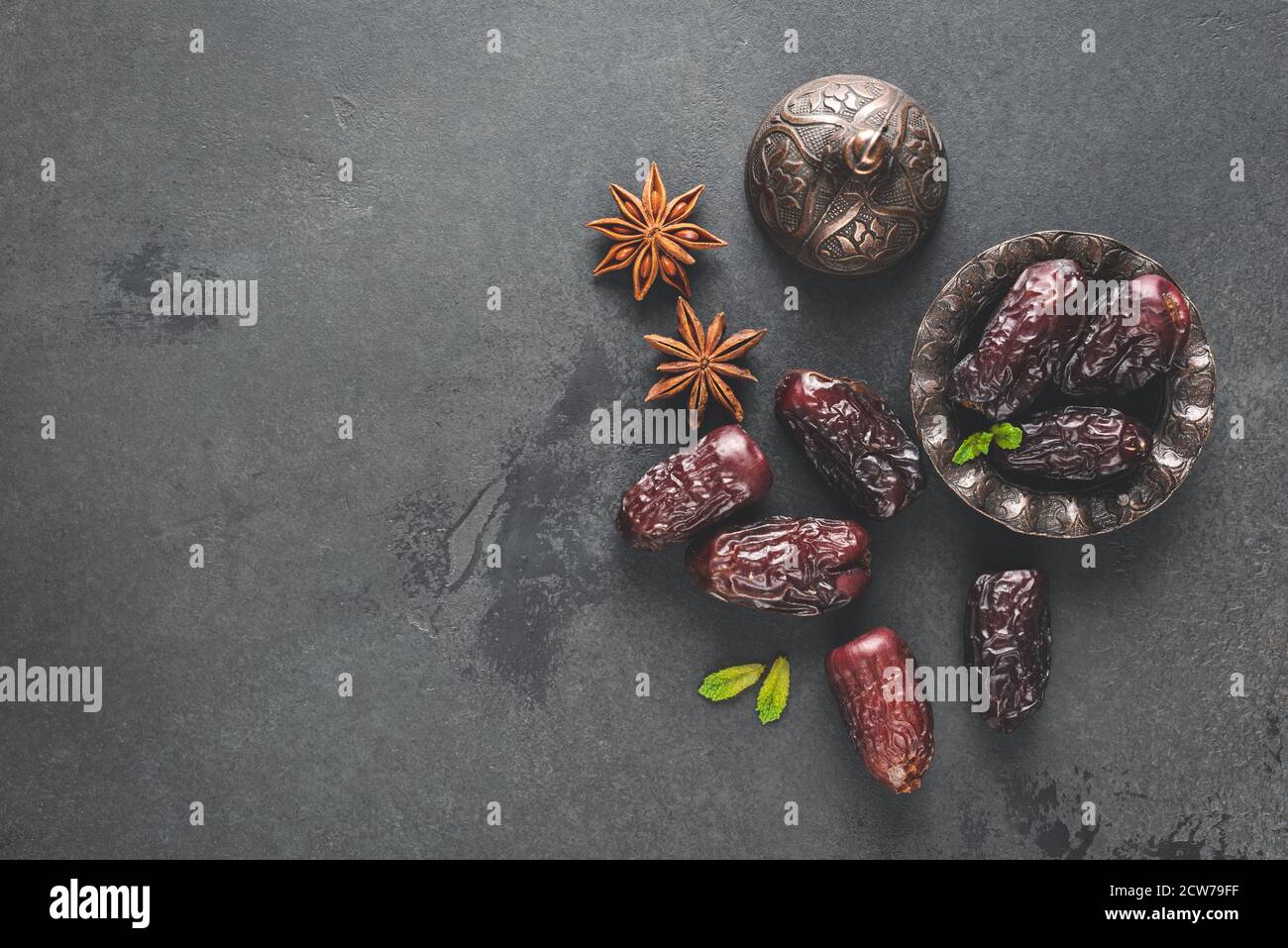 Dried dates, dried fruit on black background. Top view copy space