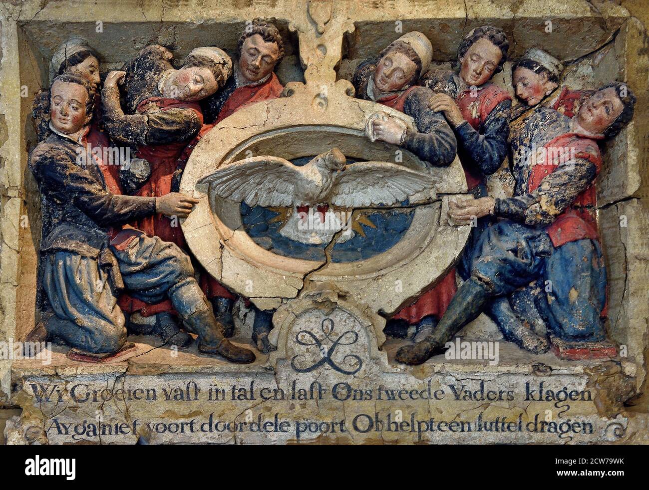 The relief by Joost Jansz. Bilhamer above the orphanage gate in Kalverstraat with orphans grouped around the emblem of the Civic Orphanage a white dove, the symbol of the Holy Spirit. The Netherlands, Dutch, Stock Photo