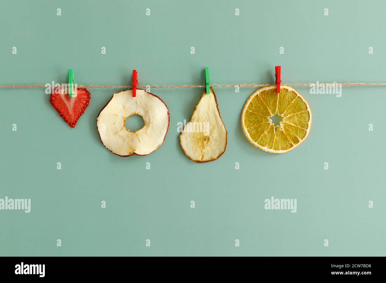 Fruit chips are dried on a rope. Healthy snacks for people who lead a ...