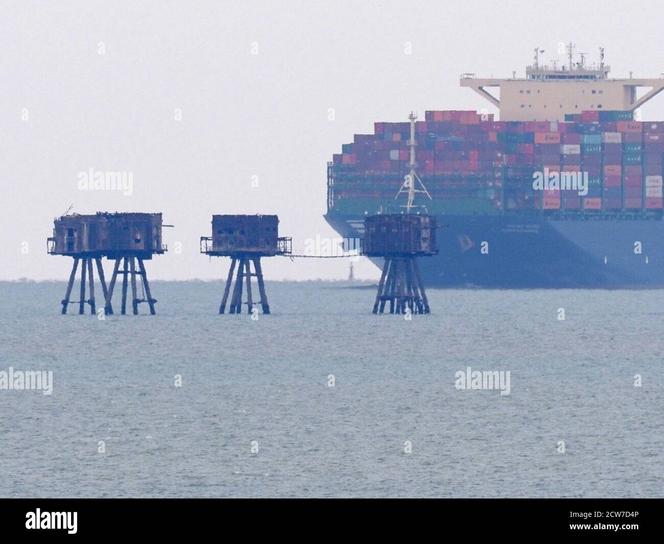 Warden, Kent, UK. 28th September, 2020. One of the world's largest container ships HMM Southampton seen passing the Red Sands Towers in the Thames Estuary from Warden, Kent at lunchtime. Credit: James Bell/Alamy Live News Stock Photo