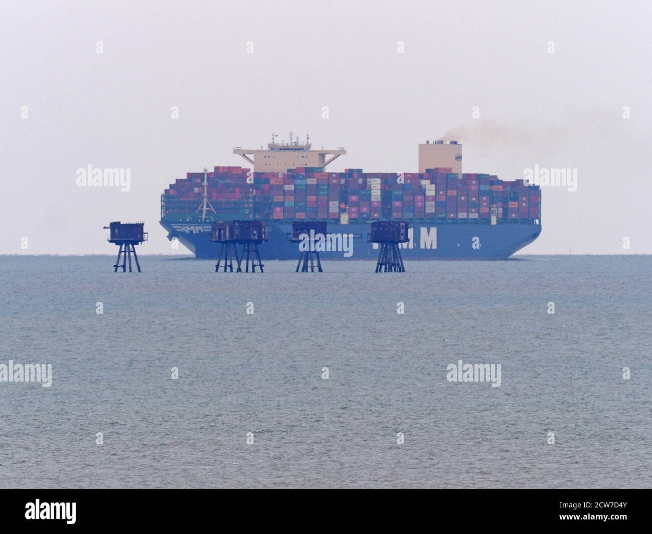 Warden, Kent, UK. 28th September, 2020. One of the world's largest container ships HMM Southampton seen passing the Red Sands Towers in the Thames Estuary from Warden, Kent at lunchtime. Credit: James Bell/Alamy Live News Stock Photo