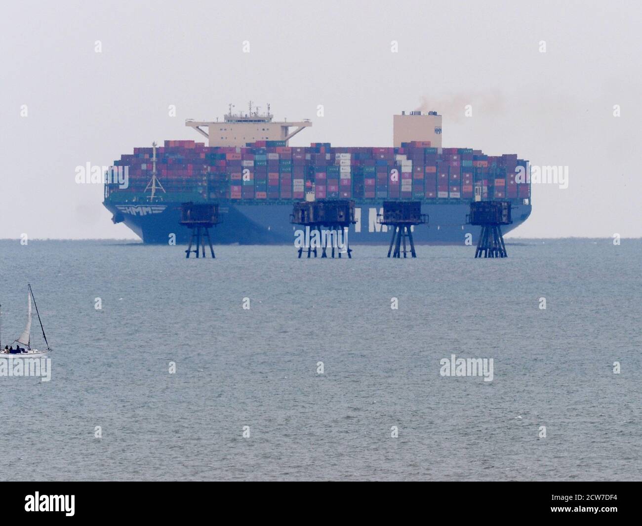 Warden, Kent, UK. 28th September, 2020. One of the world's largest container ships HMM Southampton seen passing the Red Sands Towers in the Thames Estuary from Warden, Kent at lunchtime. Credit: James Bell/Alamy Live News Stock Photo
