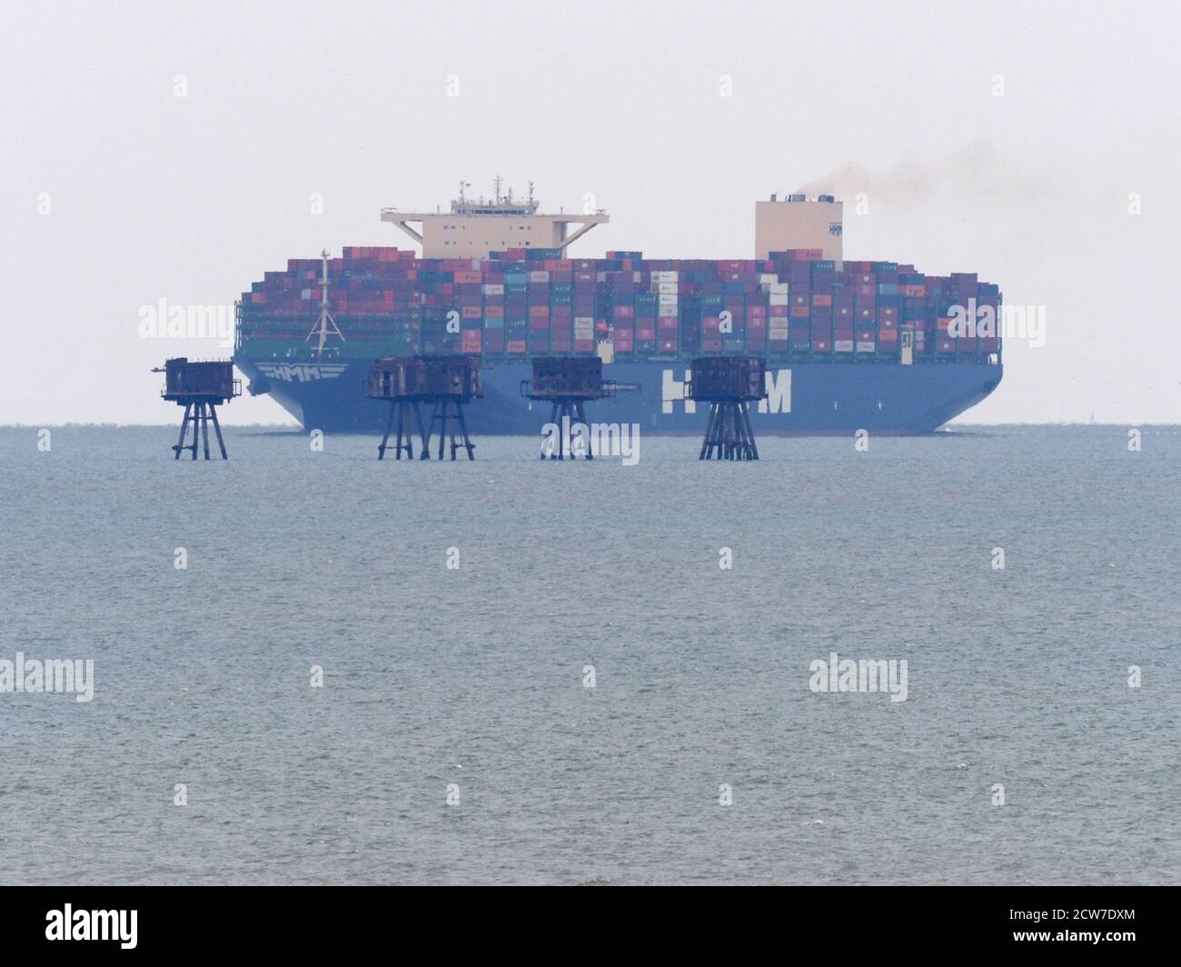 Warden, Kent, UK. 28th September, 2020. One of the world's largest container ships HMM Southampton seen passing the Red Sands Towers in the Thames Estuary from Warden, Kent at lunchtime. Credit: James Bell/Alamy Live News Stock Photo