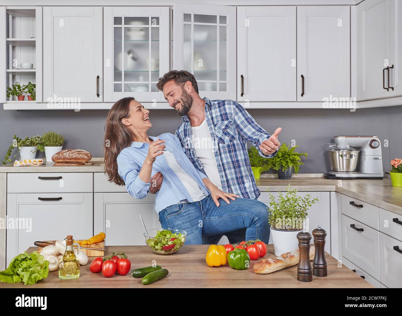 Happy couple dancing in the kitchen Stock Photo